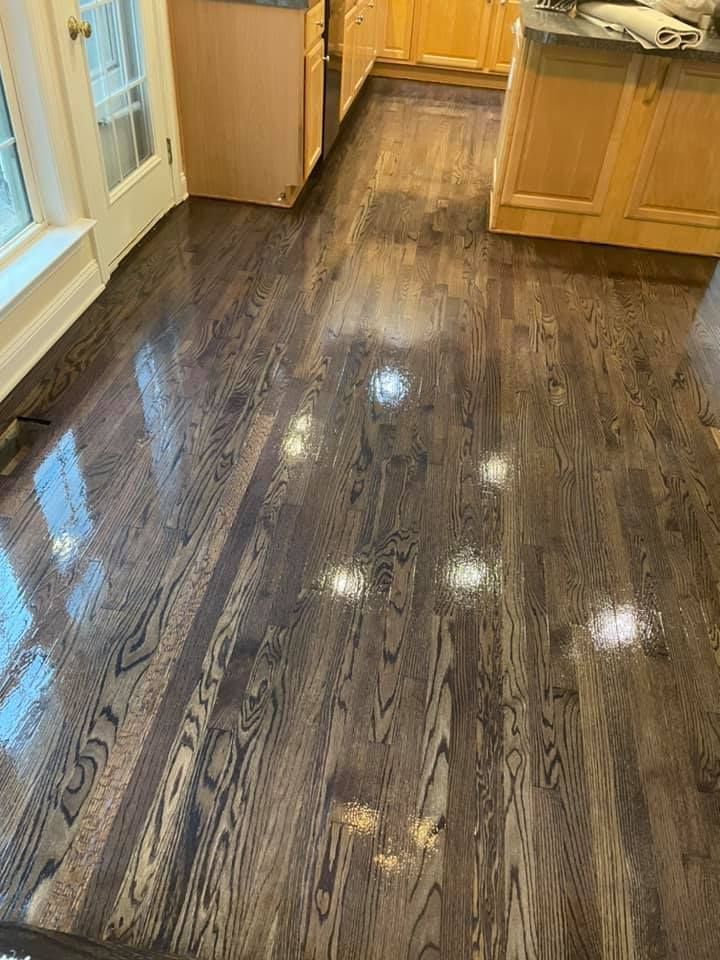 A kitchen with a wooden floor and cabinets.