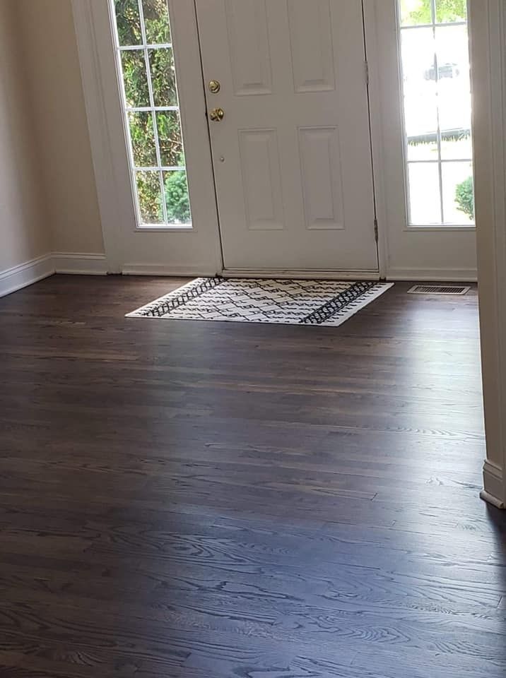 There is a rug on the floor in front of the door.