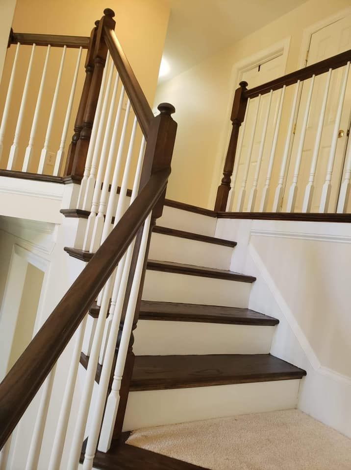 A staircase with a wooden railing and white steps