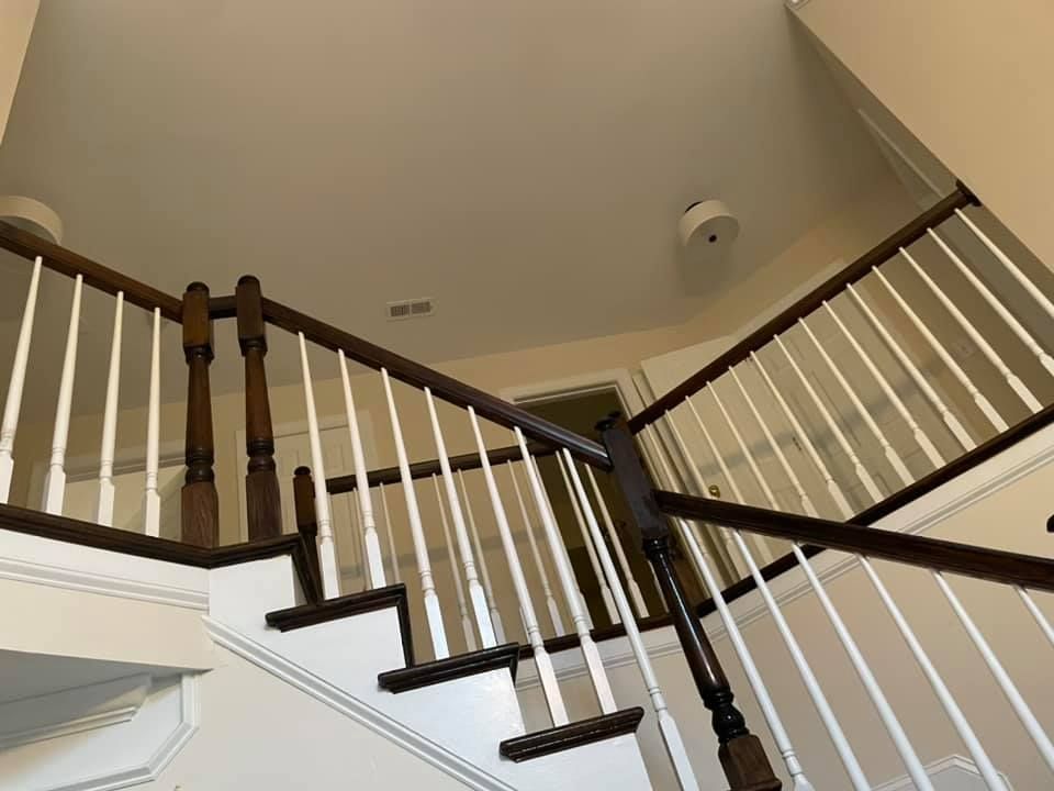 A staircase with a wooden railing and white steps