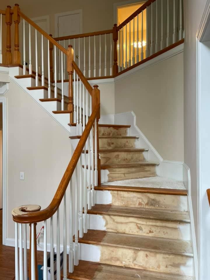 A staircase with a wooden railing and white steps