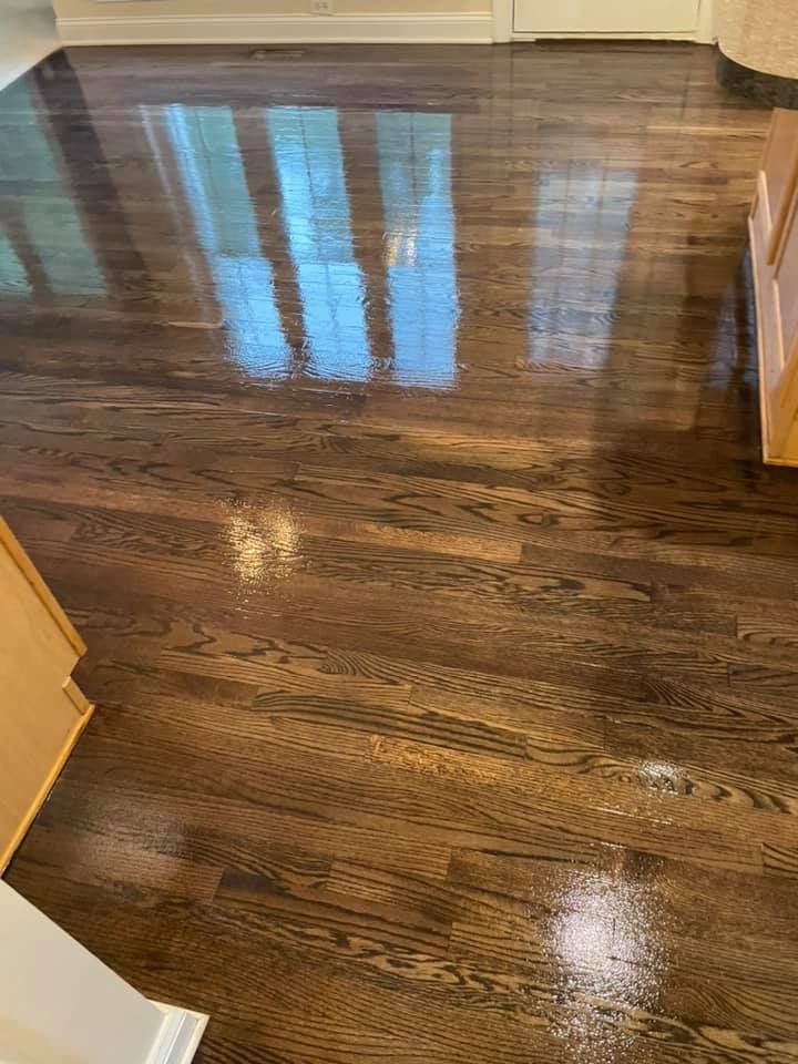 A close up of a wooden floor in a kitchen.