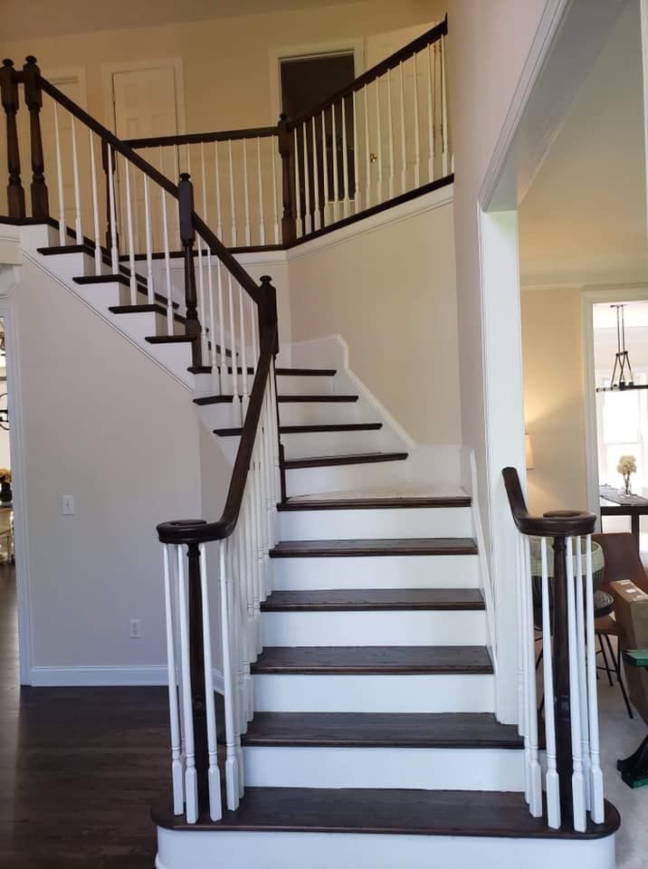 A staircase in a house with a white railing
