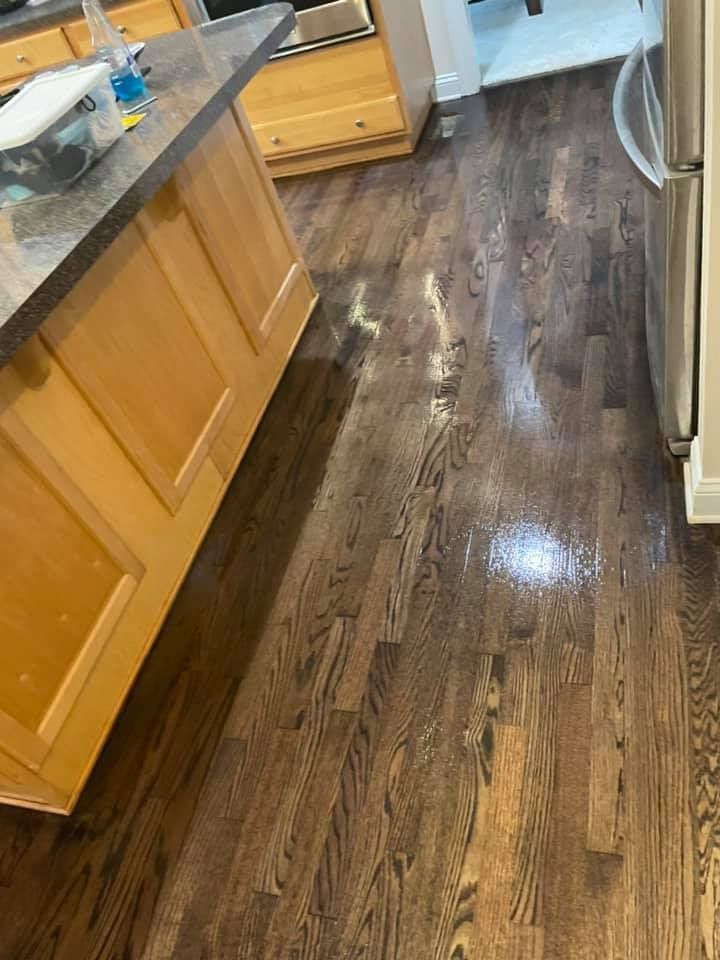 A kitchen with hardwood floors and stainless steel appliances.