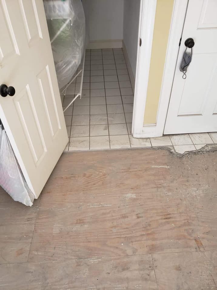 A room with a wooden floor and a white door.