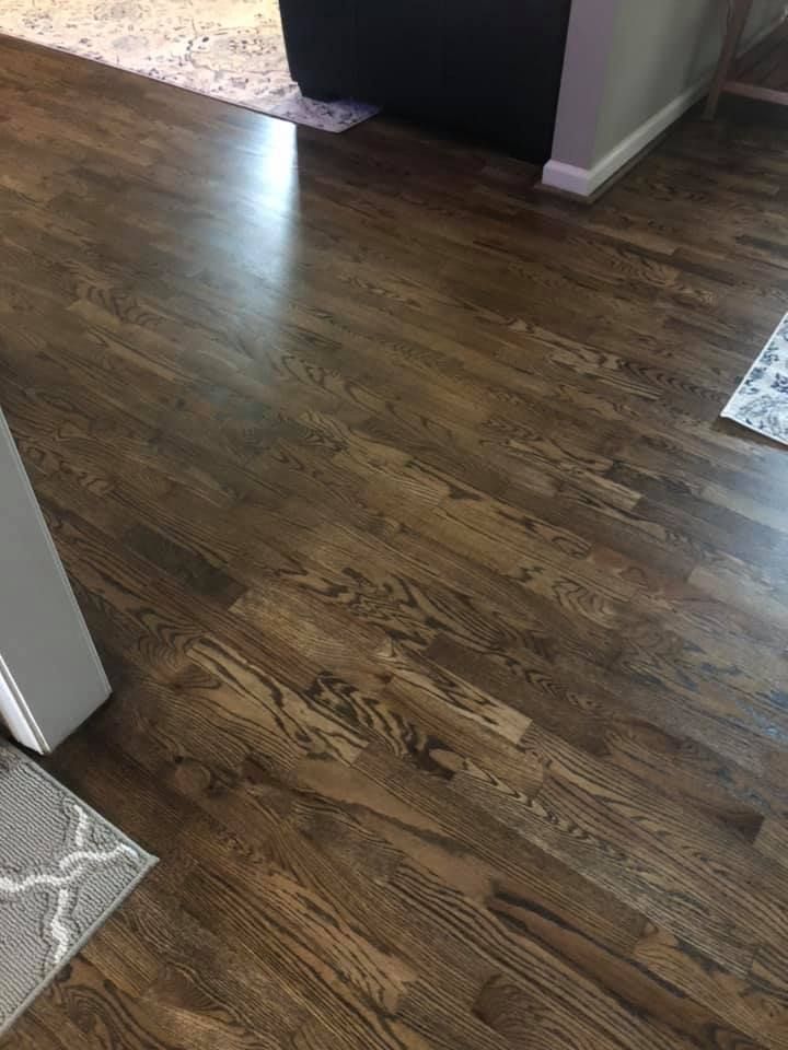 A close up of a wooden floor in a living room.