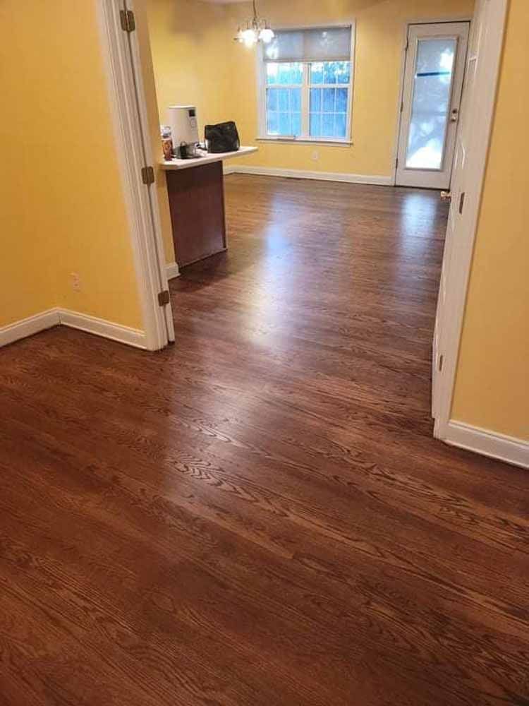 A room with hardwood floors and yellow walls.