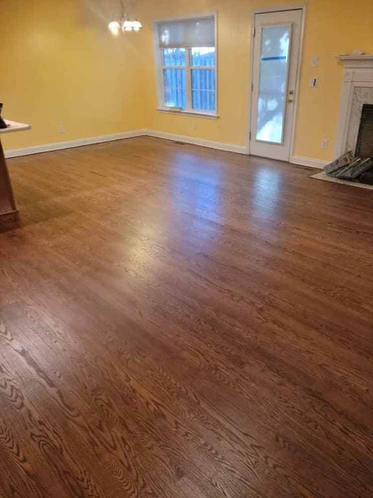 A living room with hardwood floors and a fireplace.