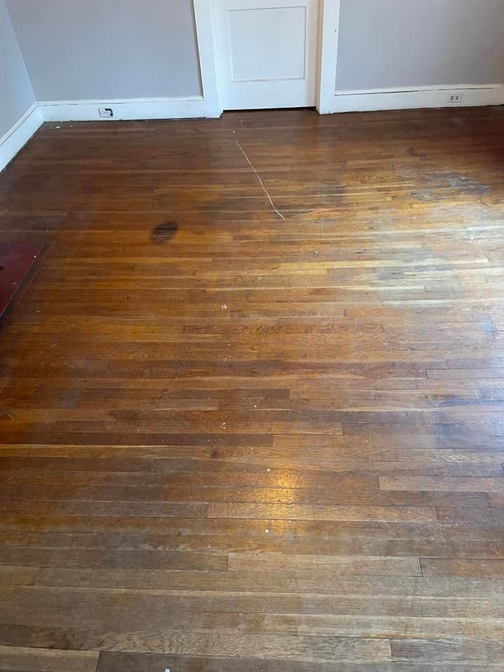 A room with a wooden floor and a door.