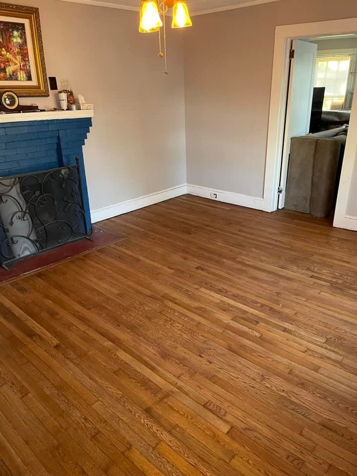 A living room with hardwood floors and a fireplace.