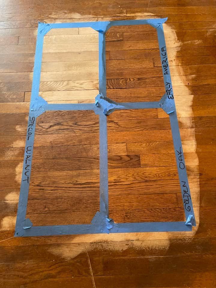 A wooden floor with a stencil on it that looks like a window.