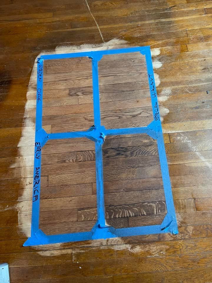 A wooden floor with a stencil on it that looks like a window.