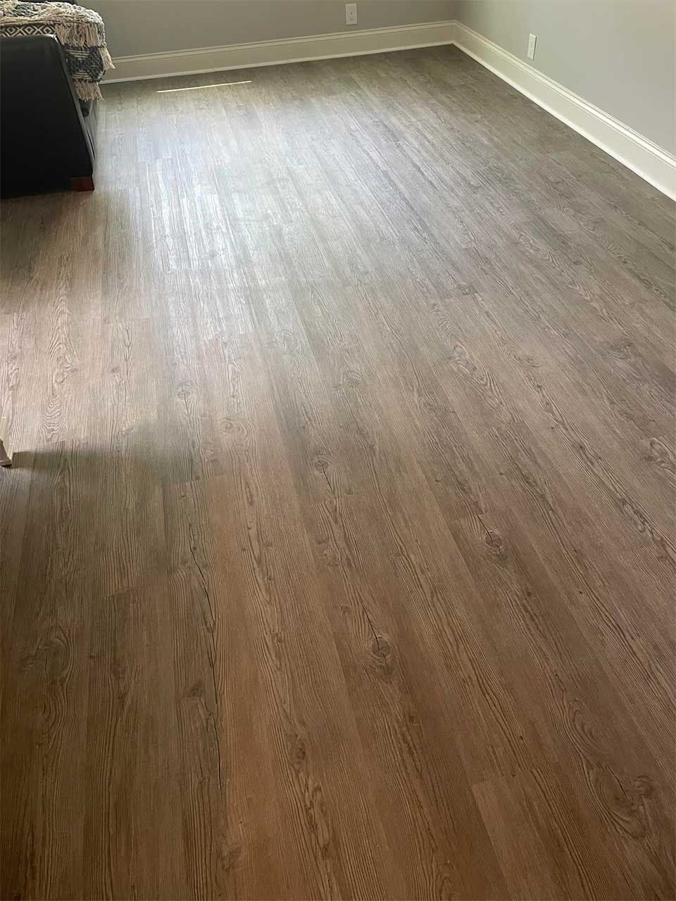 A living room with a wooden floor and a couch.