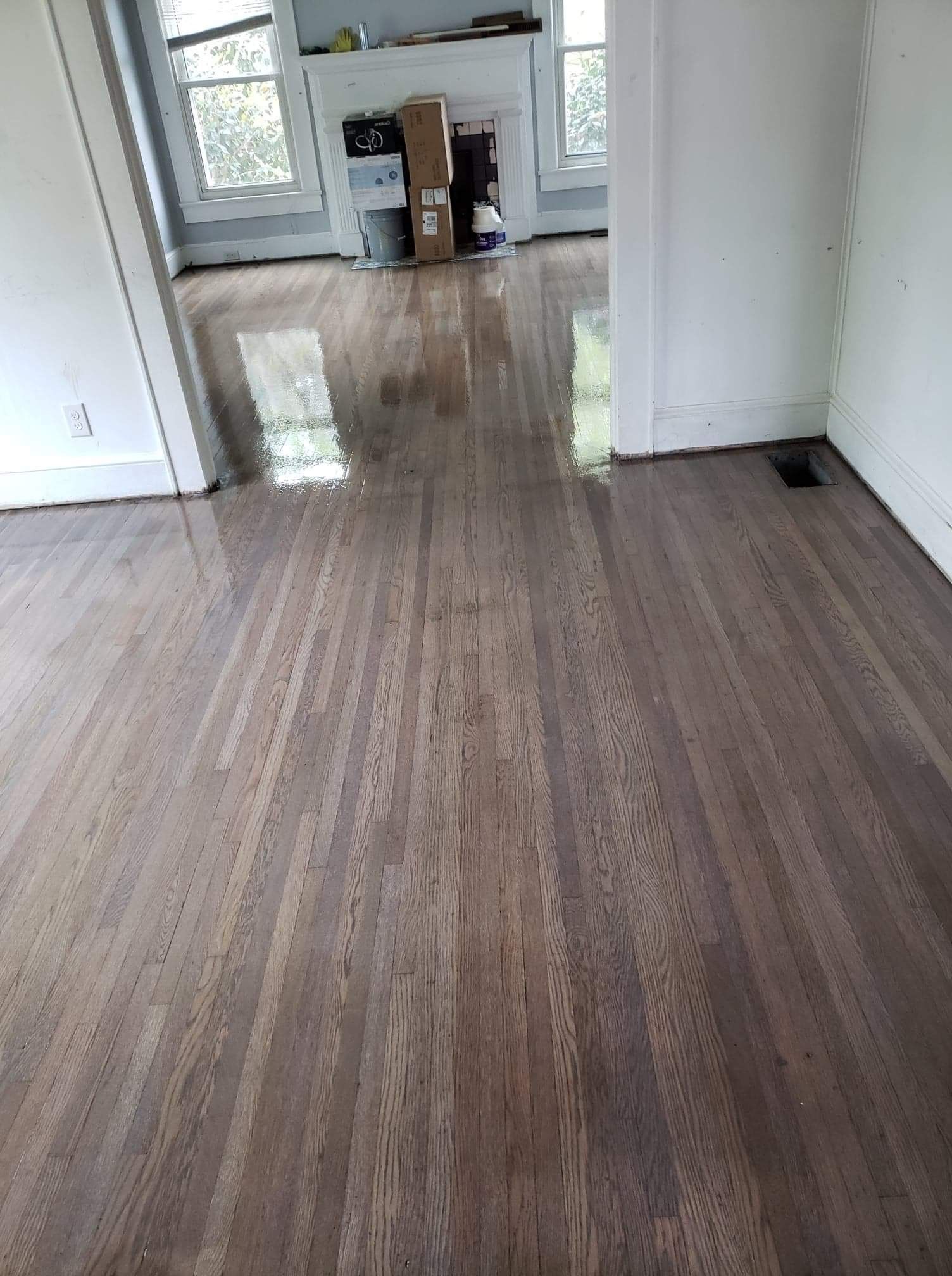 A room with a wooden floor and white walls.