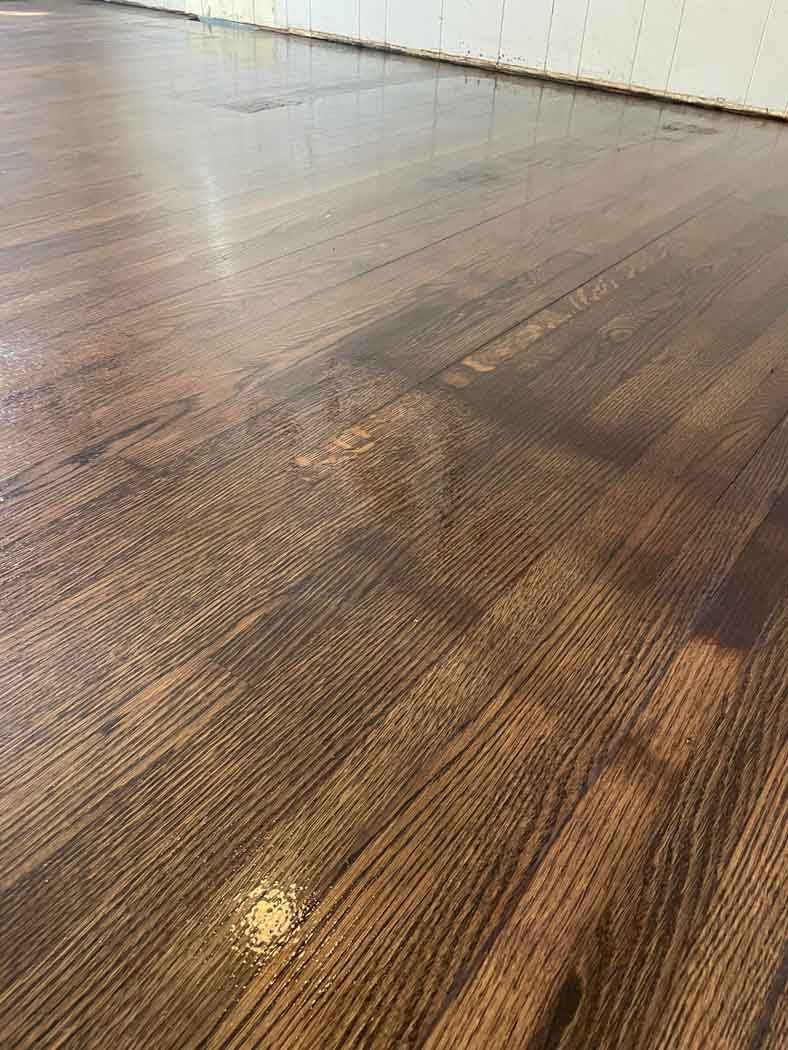 A close up of a wooden floor in a room.