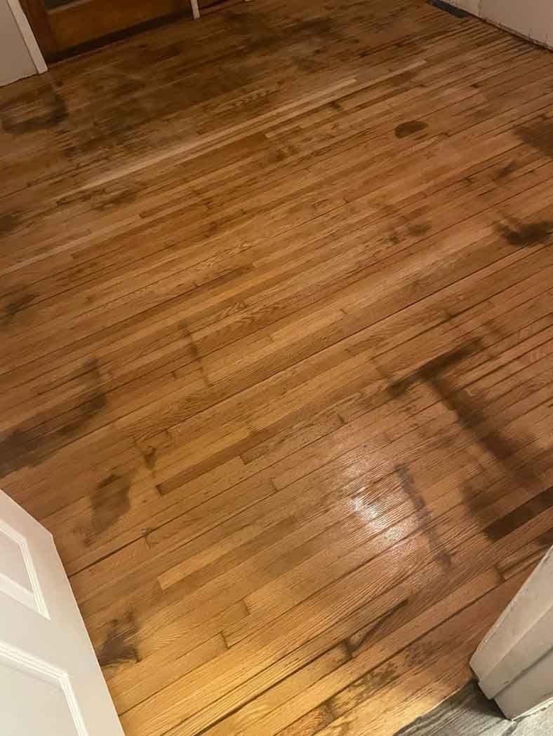 A close up of a wooden floor in a room.