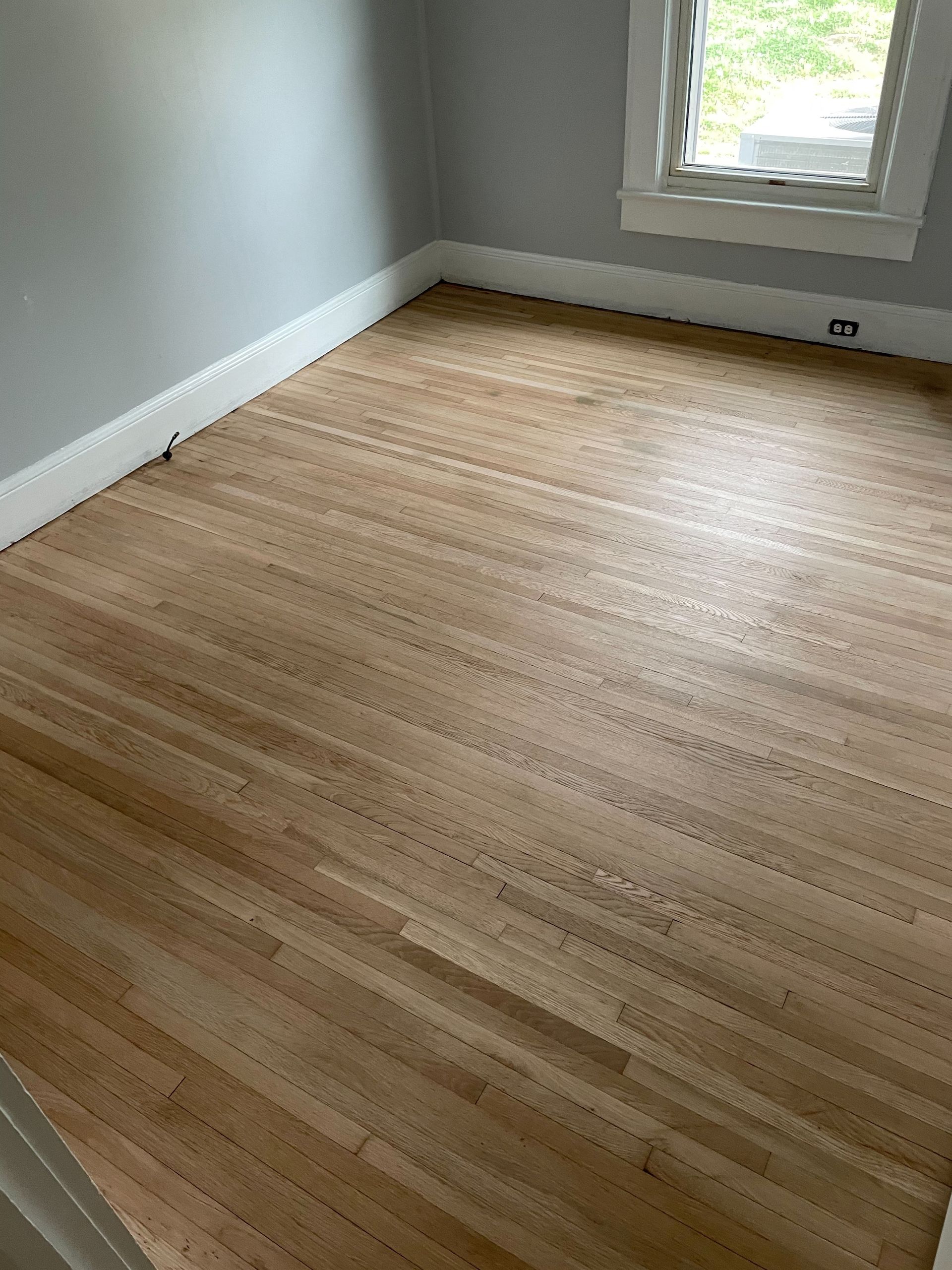 parquet floor - store salesman with flooring samples in hands.
