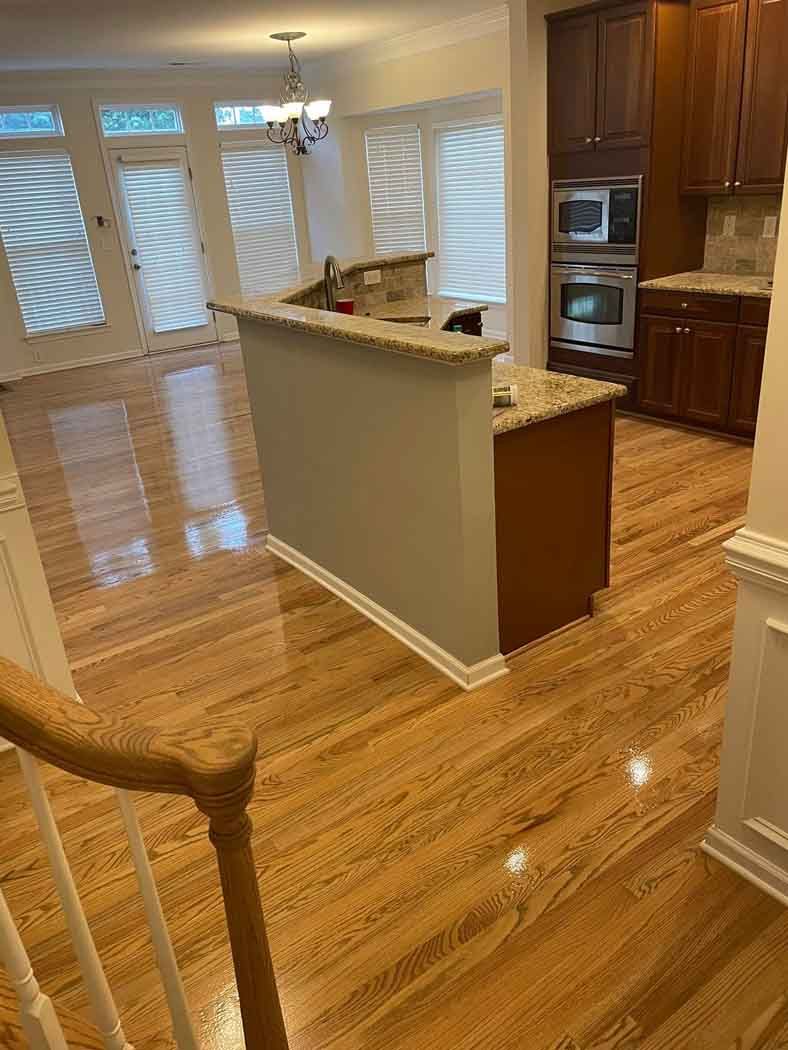 A kitchen with hardwood floors and stainless steel appliances.
