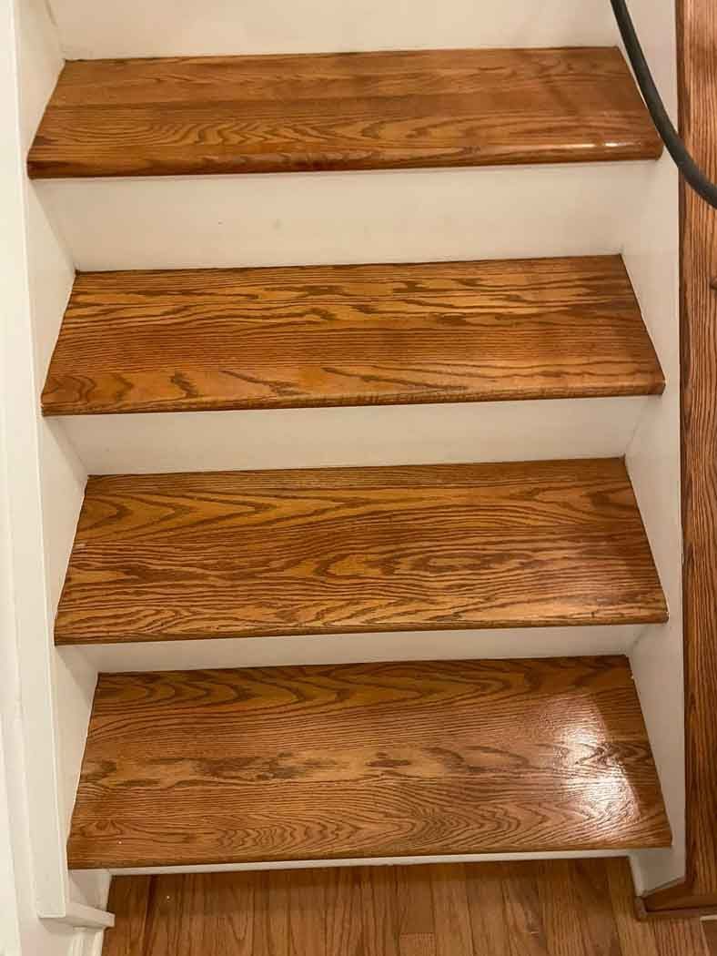 A close up of a set of wooden stairs in a house.
