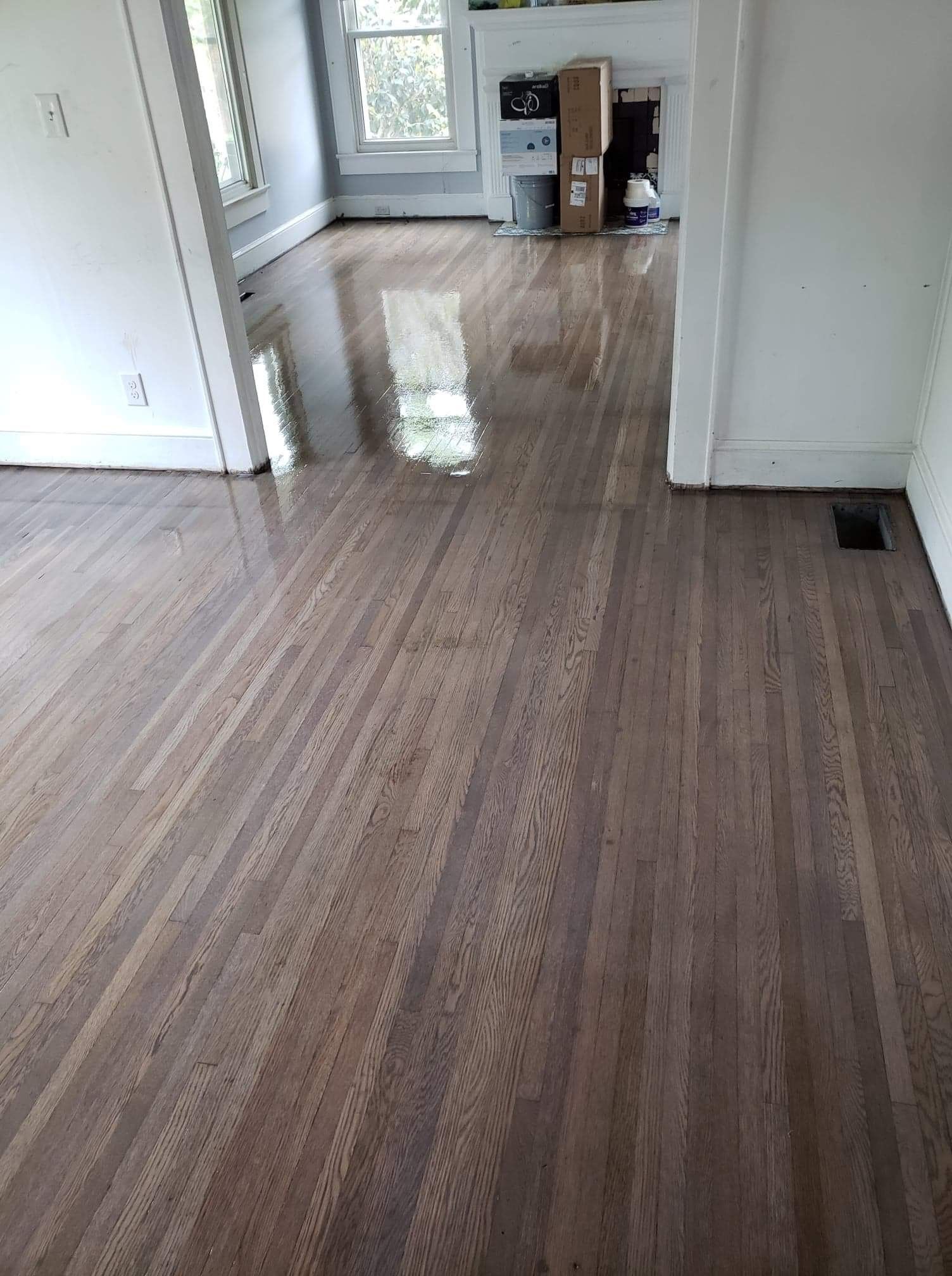 A living room with a wooden floor and white walls.