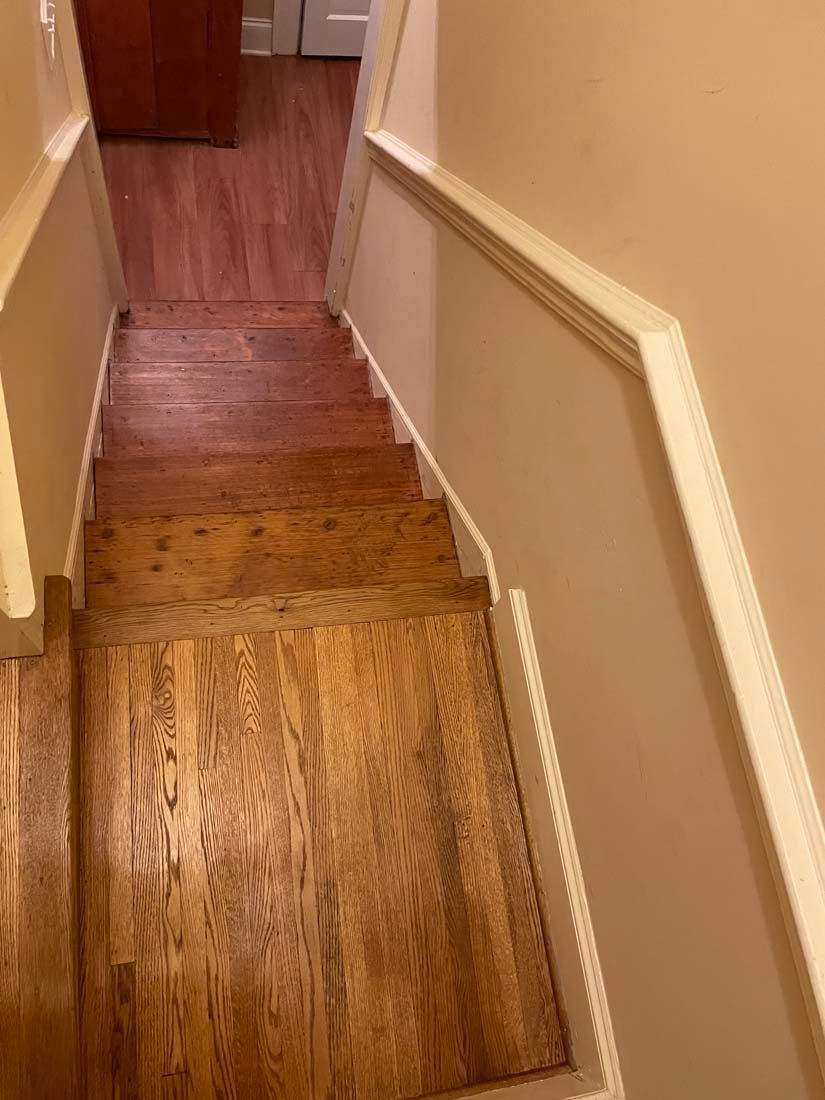 A set of wooden stairs leading up to the second floor of a house.