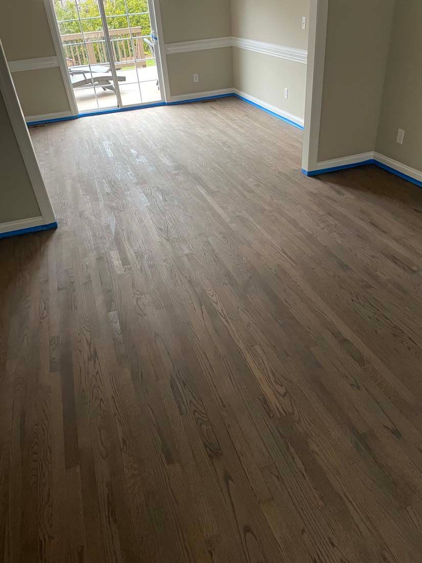 A living room with hardwood floors and a sliding glass door.