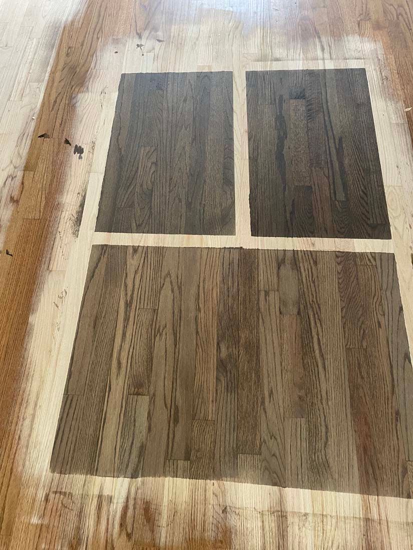 A wooden floor with a stencil on it that looks like a window.