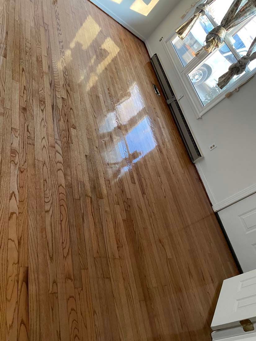 A room with hardwood floors and a window.