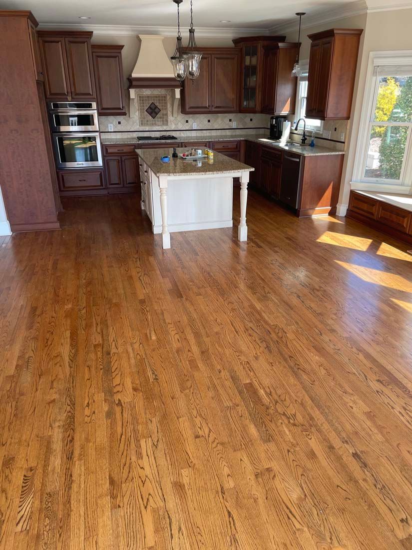 A kitchen with hardwood floors and a large island.