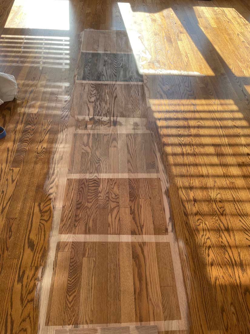 A wooden floor with a lot of different shades of wood.