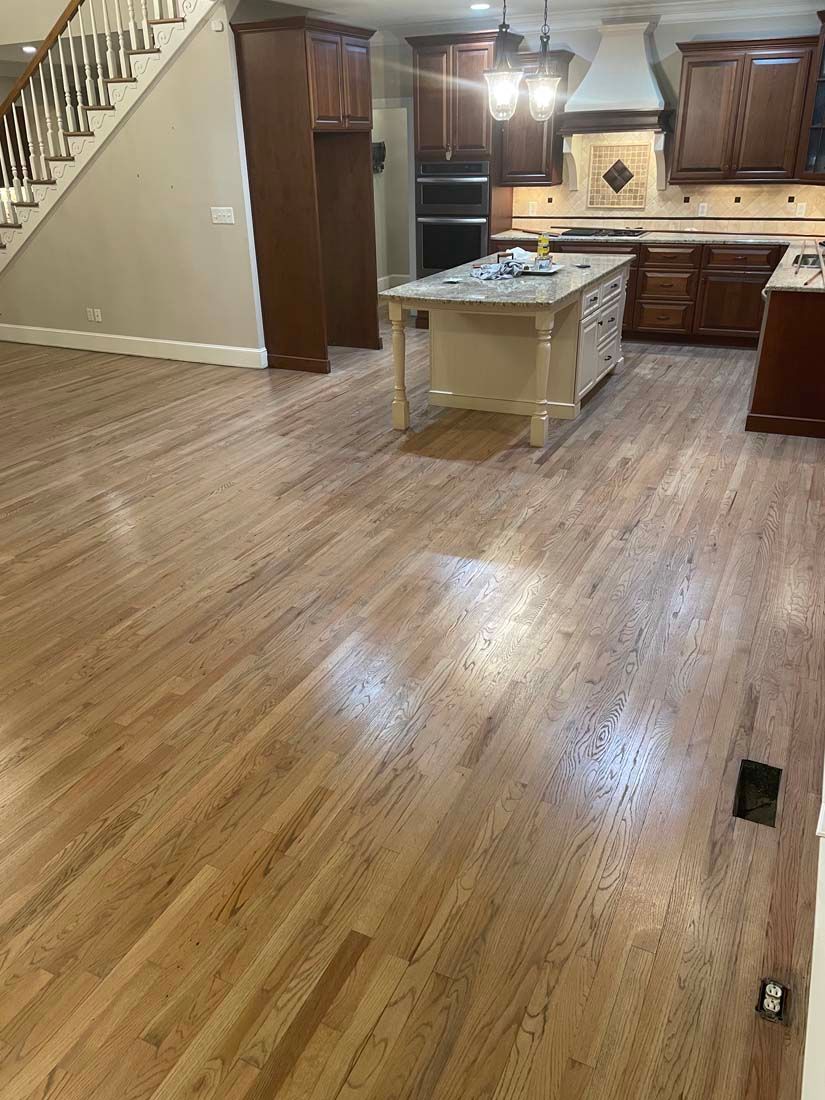 A kitchen with hardwood floors and a large island.