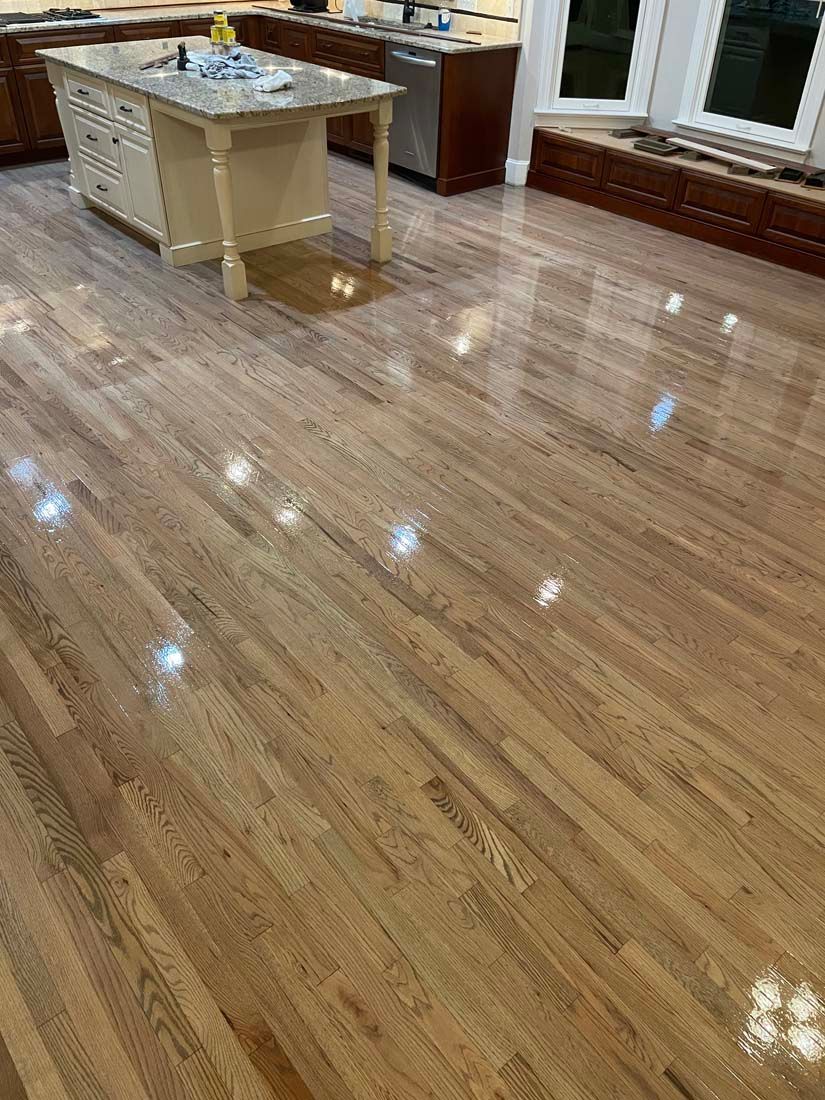 A kitchen with hardwood floors and a large island.