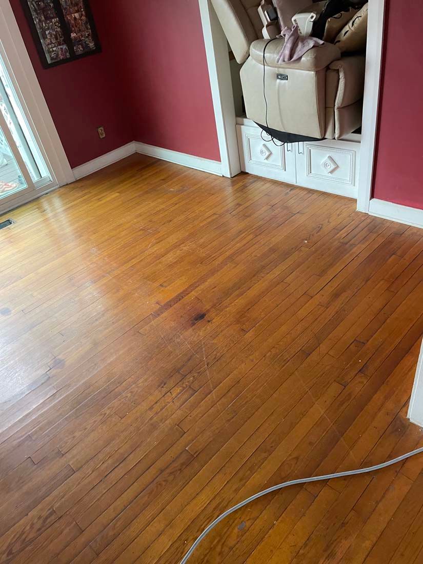 A living room with hardwood floors and red walls.