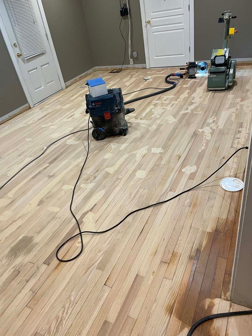 A machine is sitting on a wooden floor in a room.