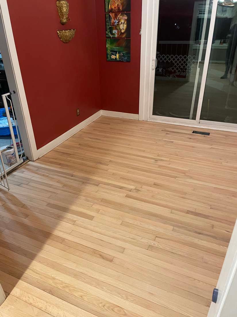 A room with a wooden floor and red walls.
