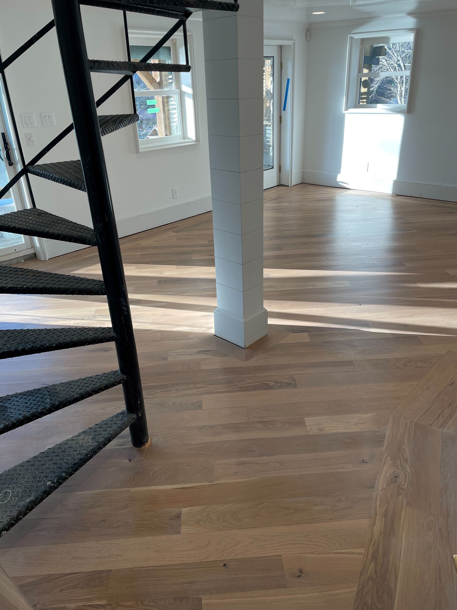 There is a spiral staircase in the middle of the room.