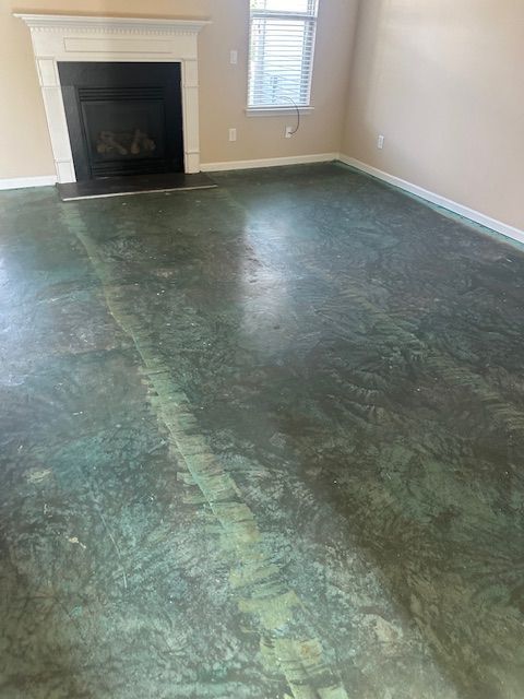 A living room with a fireplace and a green floor.