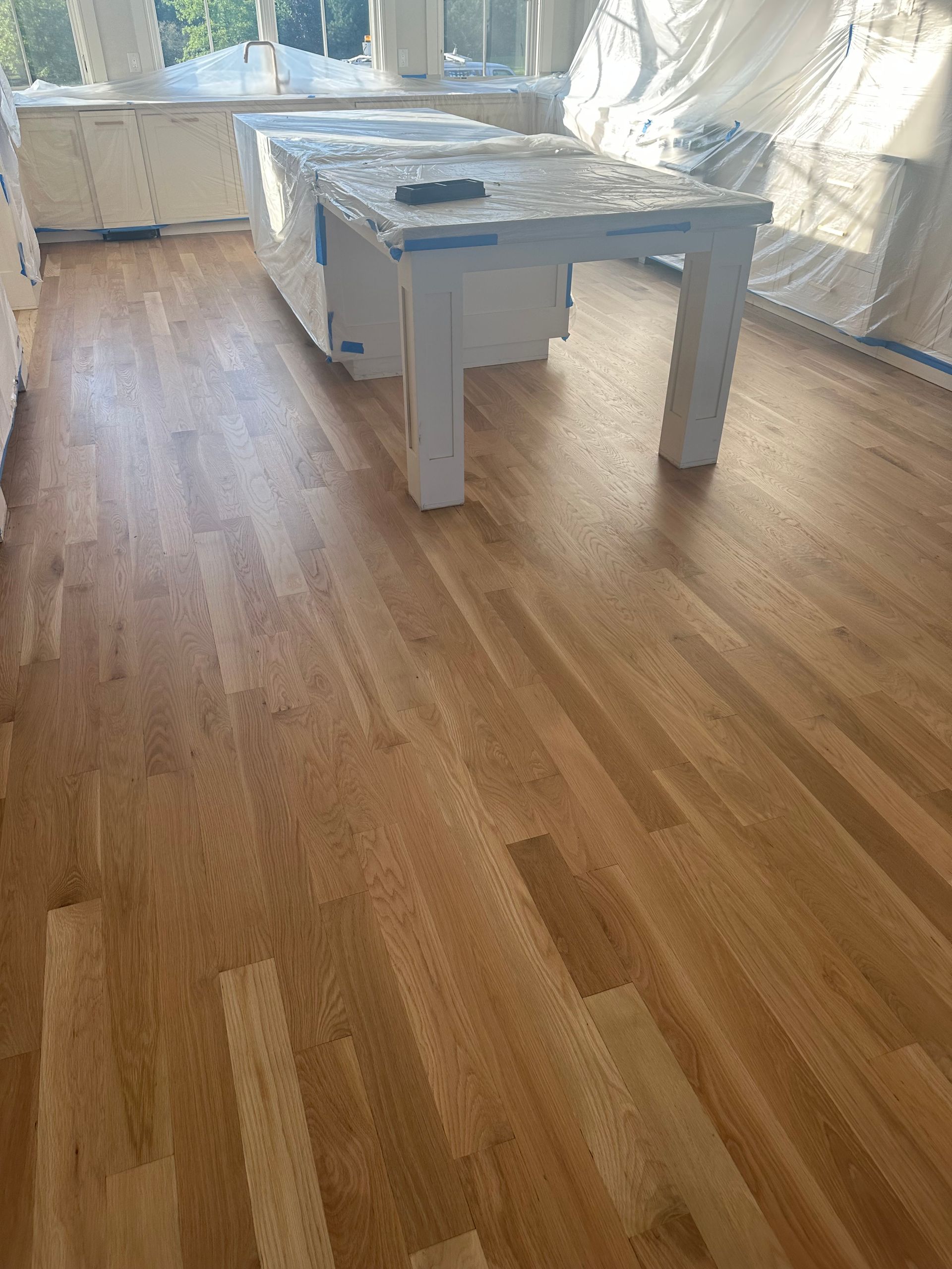 A wooden table is sitting on a wooden floor in a room.