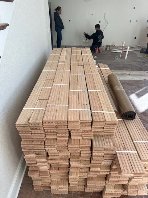 A stack of wood is sitting on the floor in a room