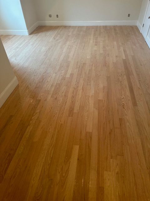 A room with a wooden floor and white walls.