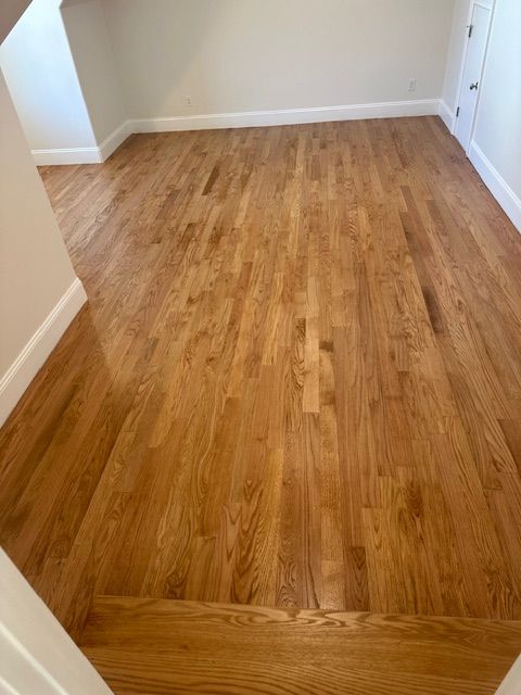 A room with hardwood floors and white walls.