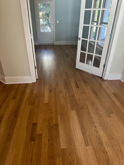 A room with hardwood floors and french doors.