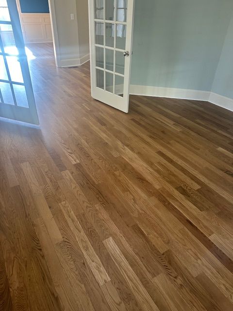 A room with hardwood floors and a french door.