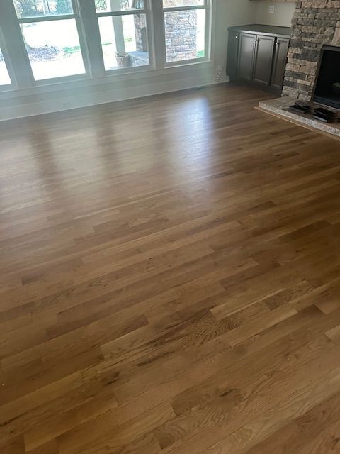 A living room with hardwood floors and a fireplace.