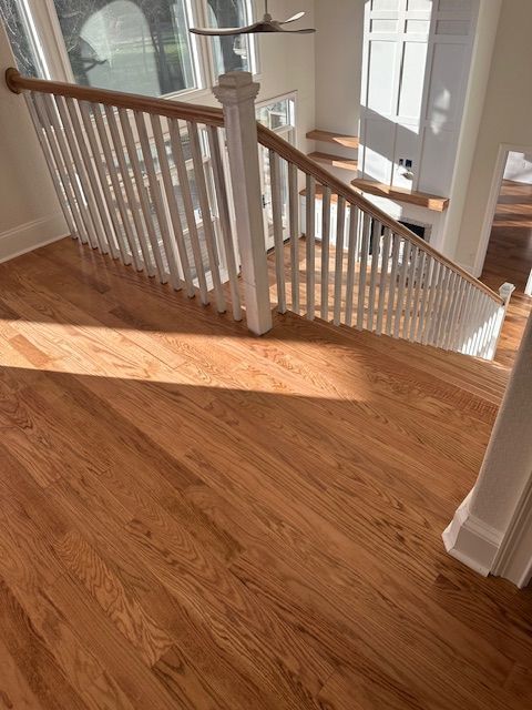 A wooden staircase with a white railing in a house.