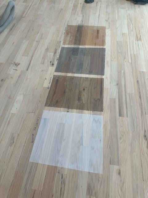 A wooden floor with four different shades of wood on it