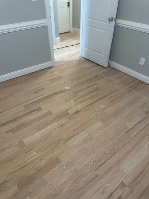 A room with hardwood floors and gray walls.