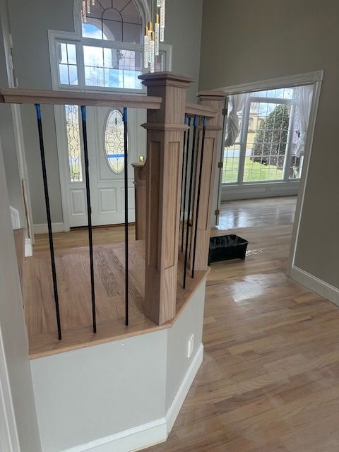 A wooden staircase with a metal railing in a house.