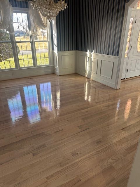 A living room with hardwood floors and a chandelier.