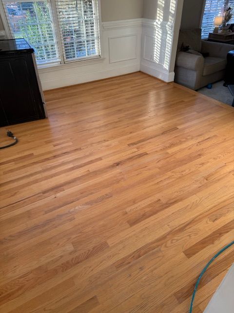 A living room with hardwood floors and a couch.